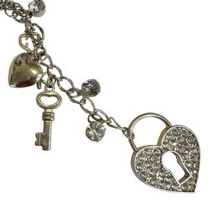 Silver tone heart and key long charm necklace